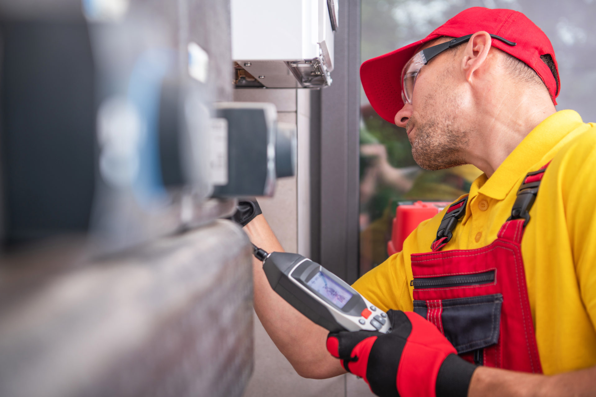 Technician with Gas Leak Detector Performing Scheduled Check Gas Monitor
